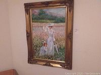 Full frontal view of the painting showing woman and child in the field with gilt wood frame.