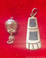 Photo of two pendants on a red background: left is a shiny sterling silver Tweety Bird pendant with detailed facial features and loop for the chain; right is a foot-shaped pendant with three turquoise inlay sections, vintage style.