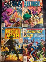 Photo showing four comic book covers including Sgt. Rock, Men of War, Rawhide Kid, and another comic