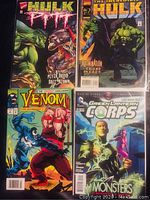 Four comic books including Hulk Pitt, The Incredible Hulk, Venom, and Green Lantern Corps issue 21