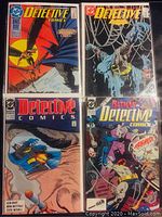 Four Batman Detective Comics with various cover artworks including a fire scene, Batman trapped in spider web, Batman in cave, and Batman being attacked by villain.