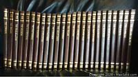 Photo of the spines of all 25 Time Life The Wild West volumes, showing uniform brown leather spine covers with gold embossed text and decorative bands.