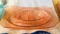 Amber carnival glass basket weave pattern dish visible with scalloped edges and intricate textured design.