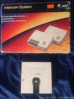 Box of AT&T 2-Way Intercom System showing product image, and original boxed Chromecast streaming device