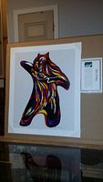 Full view of the unframed "Bear Spirit" art print by Don Chase with its colorful abstract bear figure and accompanying biography profile beside it.