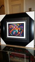 Colorful abstract art print in black professional frame with corner protectors, titled 'Rhythm of the Drum' by Don Chase.