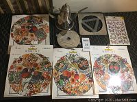 William Sonoma silver-toned coffee pot, matching metal trivet, four Royal Lace paper dollies with autumn fruit and floral designs, small vintage tin container, and butterfly sticker sheet displayed together