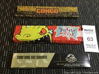 Three movie promotional watches boxes stacked in a row, showing Congo, The Rugrats Movie, and The Lost World Jurassic Park branding.