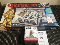 Photo of Star Wars Operation board game box with an additional Star Wars bobble head box on top.