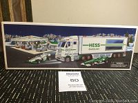 Photo showing full packaging box with image of Hess Gasoline truck, trailer, and two race cars.