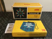 Photo of Kodak Instamatic M6 camera original box with yellow and black colors and Kodak branding.