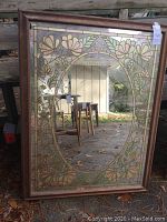 Full view of the vintage rectangular mirror with floral decorative glass frame showing oval mirror center.