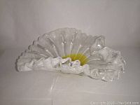 Clear and yellow art glass ruffle edge centerpiece bowl side view showing shape and color.