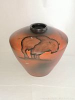 Front view of a vintage Mexican pottery vase showing a painted bull/bison design in earthy tones, highlighting its rounded shape and decorative motifs.