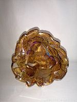 Top view of the carnival glass dish showing the leaf and berry embossed design with iridescent finish.