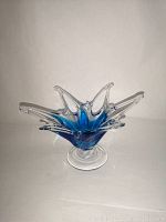 Front perspective of blue and clear art glass dish sculpture showing the shape and colors.