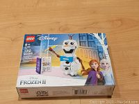 Box front showing LEGO Disney Frozen II Olaf buildable figure set number 41169 with image of Olaf and Frozen characters Anna and Elsa on winter background.