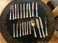Overhead view of all flatware pieces arranged on table