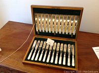 Full 12-piece fish set displayed in original wooden presentation box