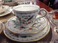 Single trio showing cup, saucer and side plate on silver tray