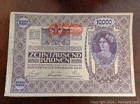 Front side of an Austro-Hungarian 10,000 Kronen banknote featuring a portrait of a woman and detailed ornate patterns.