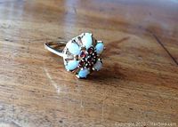 Ring laid flat on wooden surface showing full profile and head