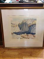Full view of framed and matted print showing landscape image in gold wood frame.