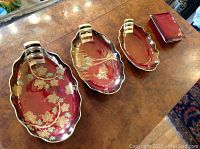 Overview of four Carlton Ware Flambe pieces: three oval dishes of varying sizes and one rectangular lidded box