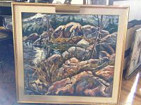 Full view of framed oil painting depicting rocky lakeshore scene