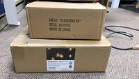 Two unopened boxes labeled Brightown G40 LED globe string lights with dimensions and product code visible.