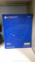 Front of box showing Etekcity EAM-DT1 twin raised air bed and branding with 100% leakage test, sleep comfort index.