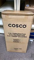 Box with product branding and description for 2-in-1 folding hand truck by Cosco