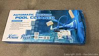 Closed box for Xtreme US Power Automatic Suction Pool Cleaner showing branding and product name with specifications.