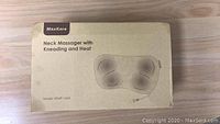 Box of MaxKare Neck Massager model XKMP-142A showing product and brand details.