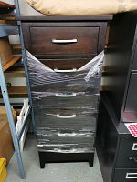 Front view of dark brown 5-drawer chest wrapped around middle drawers