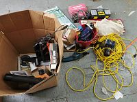Overview of cardboard box, red bucket and loose items on floor
