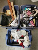 Overview of three totes with assorted household and decorative items including fishing net, shells, cables, CDs, DVDs, and miscellaneous items.