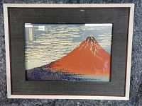 Front view of framed print showing mat, frame, and glass reflection