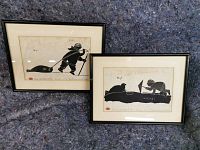 Two framed prints side by side against grey felt backdrop