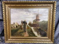 Full view of oil painting depicting Dutch country scene with figures, cows, windmills, canal, and boat framed in a large detailed gilt frame.