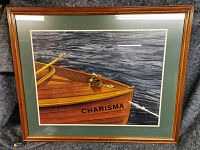 Front view of framed painting showing boat “Charisma” on water
