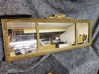 Full view of the rectangular antique wall mirror with three panels showing the entire gilt frame and mirror sections.