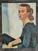 Full front view of an oil painting on canvas board featuring a seated woman in blue with brown hair tied back.