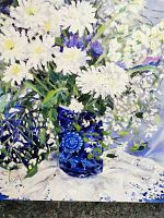 Front view of oil painting showing white daisies in blue vase on white cloth