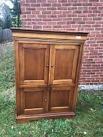 Front view of the solid maple cabinet showing the four panel doors with two upper and two lower doors closed.