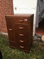 Front view of antique wood dresser showing side door on left and five drawers with wooden handles