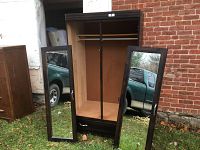 Front view of wardrobe with both mirrored doors removed showing inside hanging rod and bottom drawer