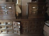 Front view showing dresser with two mirrors, drawers and cabinets with doors, flanked by two bedside tables with drawers, all finished in dark oak stain.