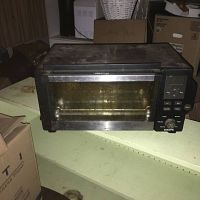 Front view of the Krups toaster oven showing glass door and control panel with buttons and dial.