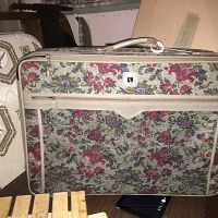 Floral pattern fabric exterior front view showing zipper and handle